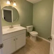 Small bathroom repainted soft green with a moisture-resistant finish in Kelowna