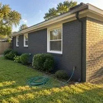 Charcoal painted brick bungalow Brick bungalow painted charcoal with white trim in Kelowna