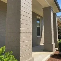 Close-up of painted brick porch columns and facade