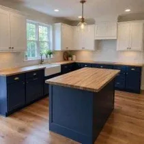 Two-tone painted kitchen with navy lower cabinets and white uppers