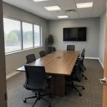 Conference room repainted soft grey under a T-bar ceiling grid in Kelowna