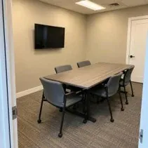 Meeting room painted warm beige with white trim