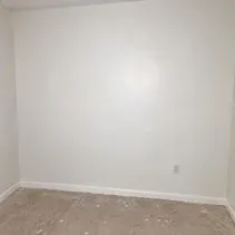 Drywall patch repaired and repainted flush with the surrounding wall