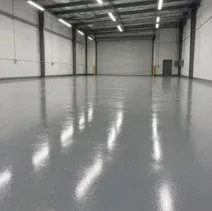 Commercial epoxy floor in a warehouse Glossy grey epoxy floor coating in a Kelowna warehouse bay