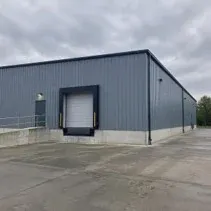 Industrial metal building repainted grey-blue with a direct-to-metal coating
