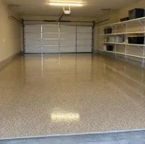 Glossy tan two-car garage epoxy floor Two-car garage with a glossy tan epoxy floor coating