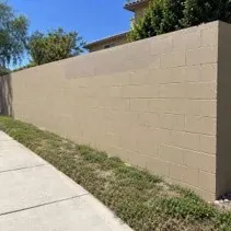 Graffiti painted out on a commercial block wall Concrete block wall painted beige over graffiti tags in Kelowna