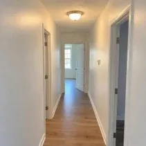 White hallway interior painting Hallway walls freshly painted white between doorways