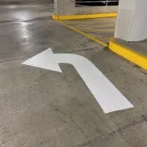 Painted directional arrow on a parking deck floor