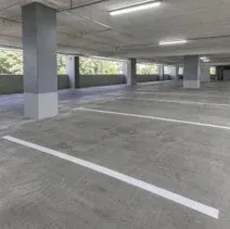 Parking garage with white line striping and painted columns