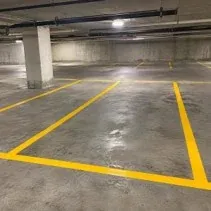 Yellow parking stall line striping Parking garage stall lines painted bright yellow in Kelowna
