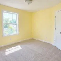 Nursery painted pale yellow in a low-odour matte finish