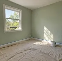 Bedroom painted soft sage with low-VOC paint in a Kelowna home