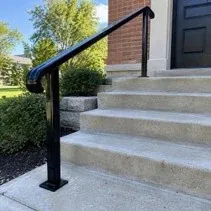 Black metal handrail repaint Exterior metal handrail repainted black on concrete steps in Kelowna