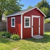 Garden shed freshly painted barn red in a Kelowna backyard