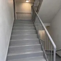 Interior stairwell repainted grey with a steel railing