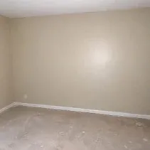 Wall repainted beige after wallpaper removal in a Kelowna home